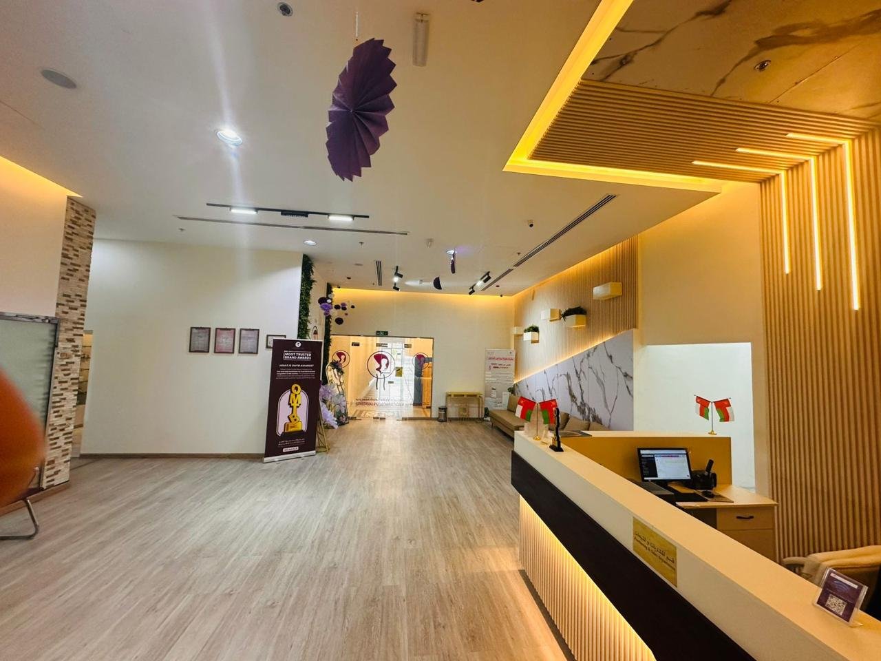 Curved reception desk with integrated LED wood slat paneling